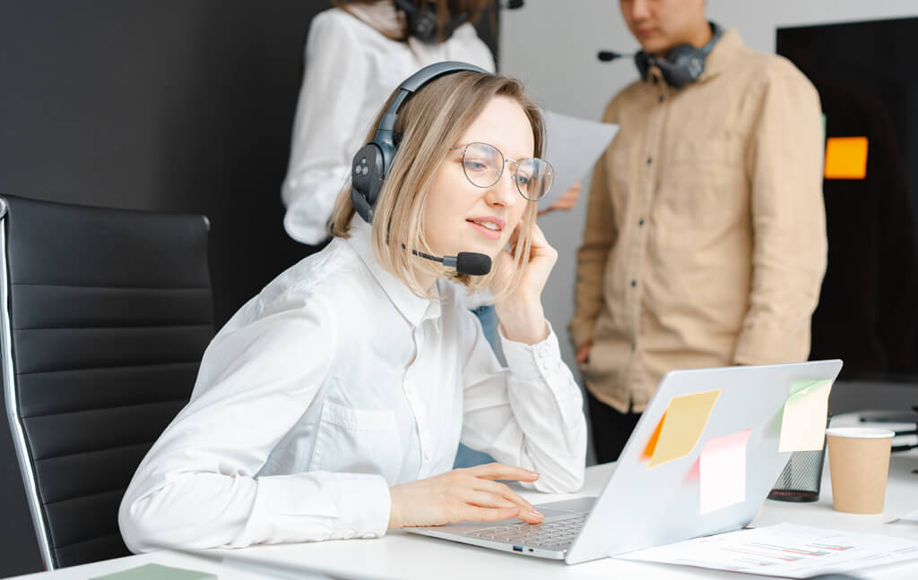 Client services team with headsets working at their desks